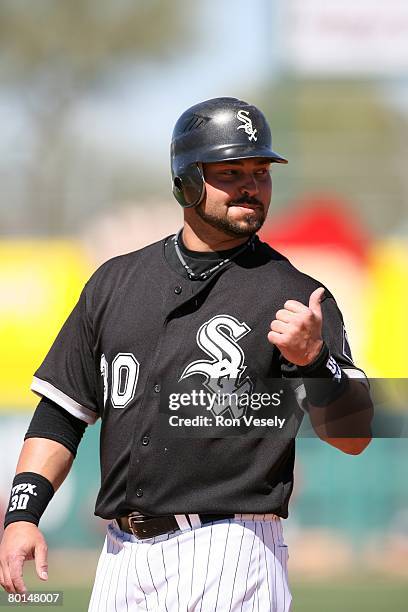 Nick Swisher of the Chicago White Sox talks to first base coach Harold Baines during the game against the Los Angeles Angels at Tucson Electric Park...