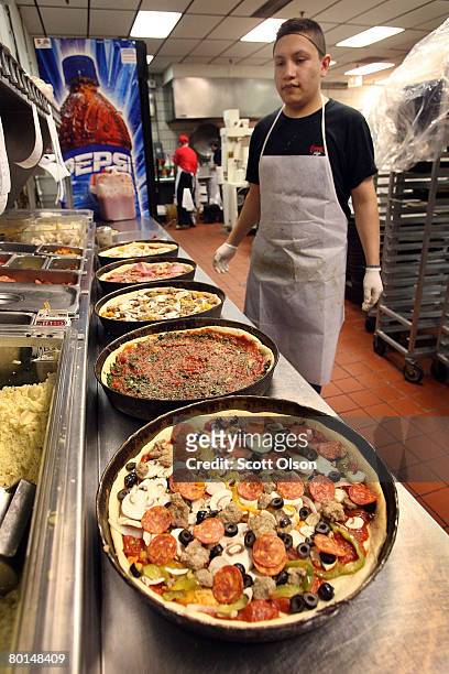 Carlos Guzman prepares a deep dish pizza at Connie's Pizza on March 6, 2008 in Chicago, Illinois. The cost of flour, a key ingredient in making pizza...