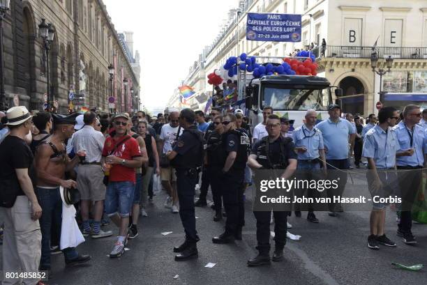 Police patrol in front of the truck organised by the association of gay police officers during a march of up to 500,000 people march to demand equal...