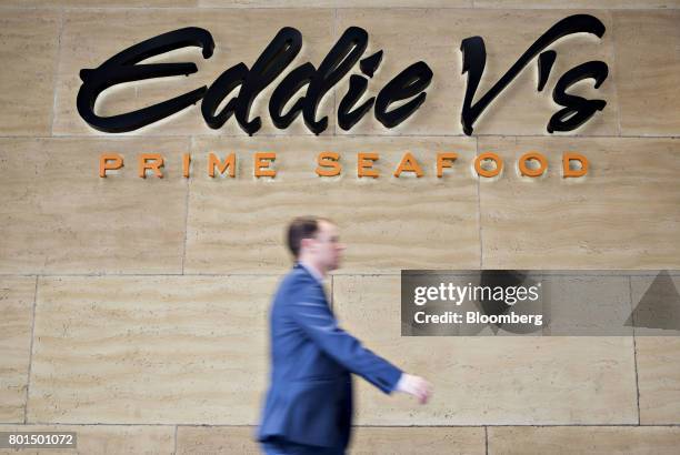 Pedestrian walks past a Darden Restaurants Inc. Eddie V's Prime Seafood location in Chicago, Illinois, U.S., on Thursday, June 22, 2017. Darden...