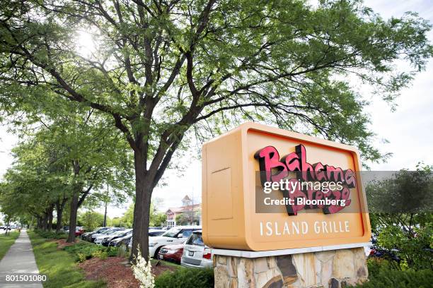 Signage is displayed outside of a Darden Restaurants Inc. Bahama Breeze Island Grille location in Schaumburg, Illinois, U.S., on Thursday, June 22,...