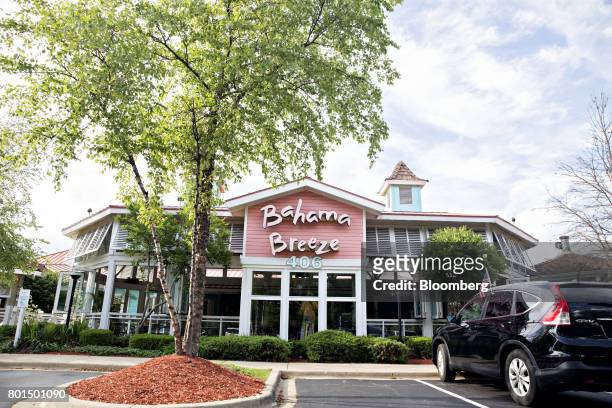 Vehicle sits parked outside of a Darden Restaurants Inc. Bahama Breeze Island Grille location in Schaumburg, Illinois, U.S., on Thursday, June 22,...