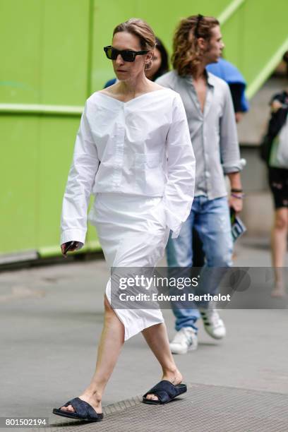 Guest wears a white dress, outside the Y-3 show, during Paris Fashion Week - Menswear Spring/Summer 2018, on June 25, 2017 in Paris, France.