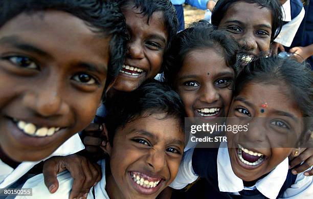 Malaysia-vote-Indians by M. Jegathesan Young ethnic Indian children smile for the camera while waiting for their bus at a Tamil language primary...