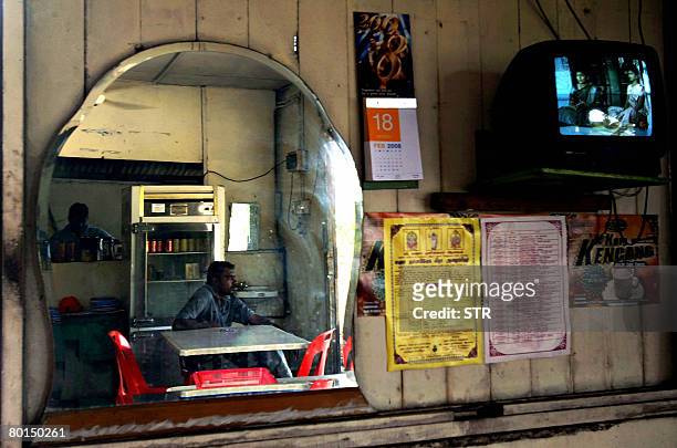 Malaysia-vote-Indians by M. Jegathesan Ethnic Indians sit at a coffeeshop at the Tuan Mee oil palm estate in Batang Berjuntai, about 100 kilometres...