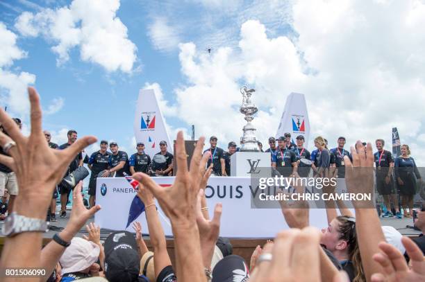 Emirates Team New Zealand on stage moments before being presented with the America's Cup America's Cup in the Great Sound during the 35th America's...