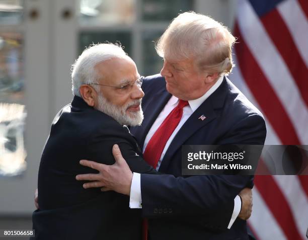 President Donald Trump and Indian Prime Minister Narendra Modi embrace while delivering joint statements in the Rose Garden of the White House June...
