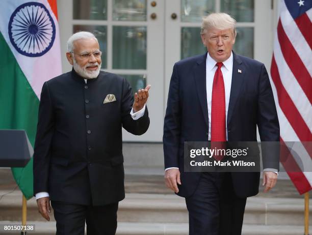 President Donald Trump and Indian Prime Minister Narendra Modi walk up to deliver joint statements in the Rose Garden of the White House June 26,...