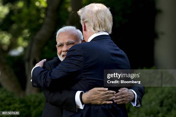 Narendra Modi, India's prime minister, left, hugs U.S. President Donald Trump during a joint statement in the Rose Garden of the White House in...