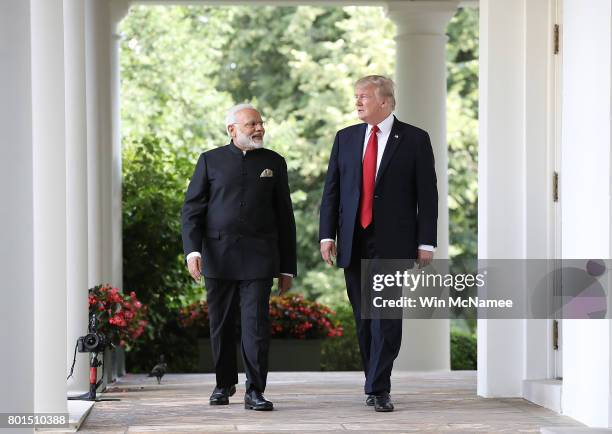 President Donald Trump and Indian Prime Minister Narendra Modi walk from the Oval Office to deliver joint statements in the Rose Garden of the White...