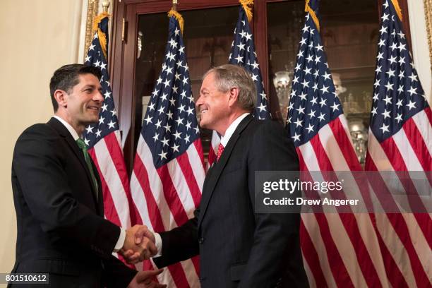 Speaker of the House Paul Ryan shakes hands with Representative-elect Ralph Norman during in a ceremonial swearing-in on Capitol Hill, June 26, 2017...