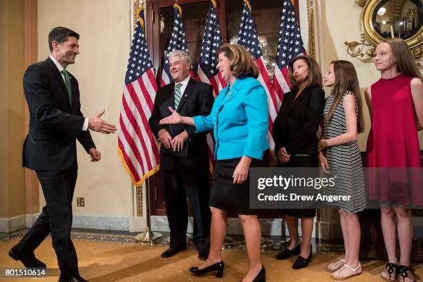 Steve Handel looks on Speaker of the House Paul Ryan arrives and shakes hands with Representative-elect Karen Handle before a ceremonial swearing-in...