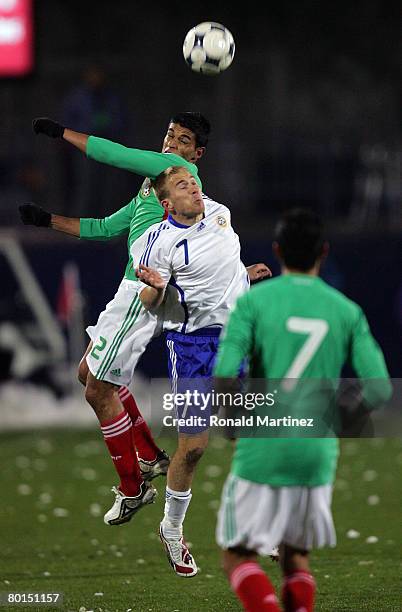 Defenseman Francisco Gamboa of Mexico battles for a header with Kari Arkivu of Finland during an exhibition match on March 6, 2008 at Pizza Hut Park...