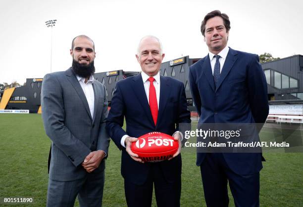 Bachar Houli of the Tigers, Malcolm Turnbull, Prime Minister of Australia and Gillon McLachlan, Chief Executive Officer of the AFL pose for a photo...