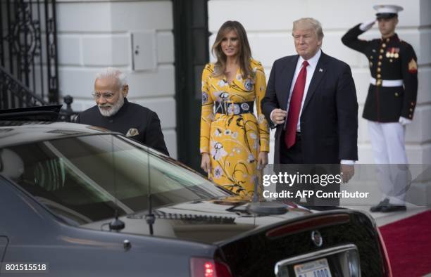 President Donald Trump and First Lady Melania Trump bid farewell to Indian Prime Minister Narendra Modi on the South Lawn of the White House in...