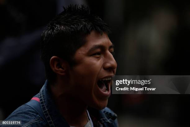 Classmate of the 43 missing students of Ayotzinapa shouts slogans during a demonstration to commemorate the 1000 days anniversary of the...