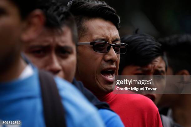 Classmates of the 43 missing students of Ayotzinapa shout slogans during a demonstration to commemorate the 1000 days anniversary of the...