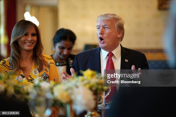 President Donald Trump, right, delivers remarks as U.S. First Lady Melania Trump smiles before dinner with Narendra Modi, India's prime minister, at...