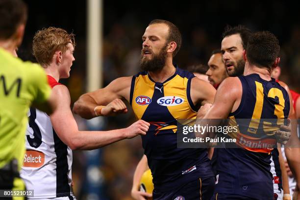 Will Schofield of the Eagles raises his forearm towards Clayton Oliver of the Demons at the end of the second quarter during the round 14 AFL match...