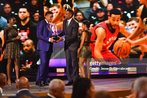 Legend Grant Hill and Jada Pinkett-Smith presents Malcolm Brogdon of the Milwaukee Bucks with the Rookie of the Year award during the 2017 NBA Awards...