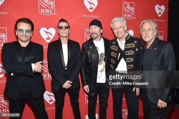 Bono, Larry Mullen Jr., The Edge, Adam Clayton of U2 pose for the photo with President/CEO of The Recording Academy and MusicCares Neil Portnow at...
