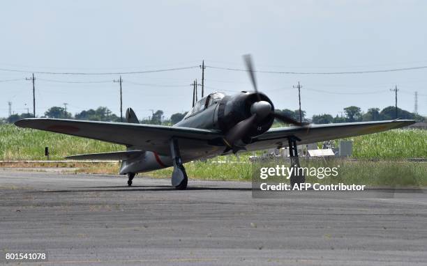 This picture taken on June 9, 2017 shows a restored World War II-era Mitsubishi A6M Type 22 Zero fighter travelling along a runway at an airfield in...