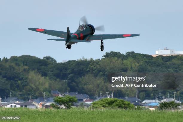 This picture taken on June 9, 2017 shows a restored World War II-era Mitsubishi A6M Type 22 Zero fighter taking off from an airfield in Ryugasaki,...