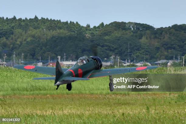 This picture taken on June 9, 2017 shows a restored World War II-era Mitsubishi A6M Type 22 Zero fighter taking off from an airfield in Ryugasaki,...