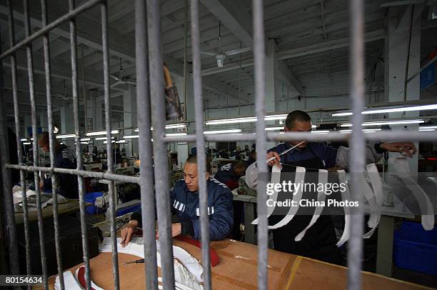 Inmates work in a sewing workshop at a prison on March 7, 2008 in Chongqing Municipality, China. There are nearly 5,000 inmates in the prison. China...