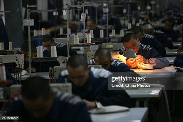 Inmates work on sewing machines at a prison on March 7, 2008 in Chongqing Municipality, China. There are nearly 5,000 inmates in the prison. China is...