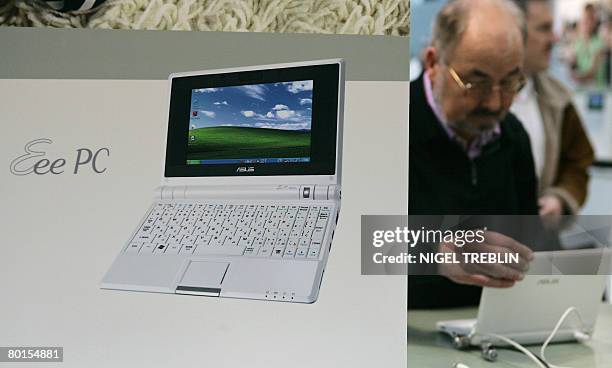 Trade fair visitor checks out the labtop "Eee PC" made by Asus at the CeBIT trade fair in Hanover on March 7, 2008. The fair officially runs from 04...