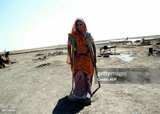 Eighty year old Indian woman Vahaliben Ramsingbhai Bhimani walks with the aid of crutches around her home in the Little Rann of Kutch in the...