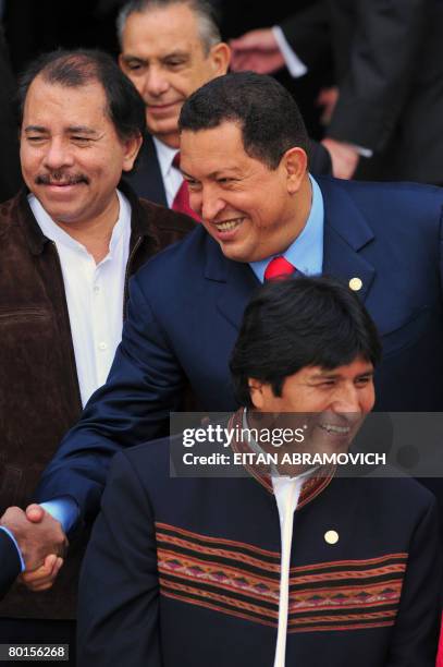 Venezuela's President Hugo Chavez shakes hands with Guyana's Prime Minister Bharrat Jagdeo between Nicaragua's President Daniel Ortega and their...