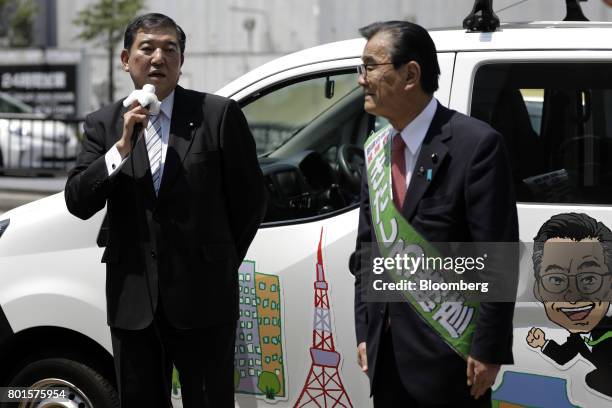 Shigeru Ishiba, a member of the Liberal Democratic Party and the House of Representatives, left, speaks during an election campaign event for...