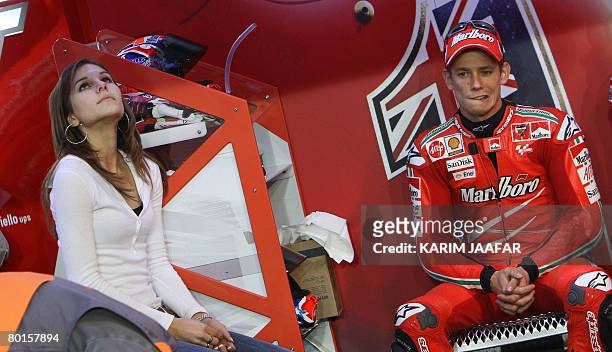 Australian rider Casey Stoner sits next to his wife Adriana as she watches the monitor during the 2008 MotoGP free practice in Doha on March 7, 2008....