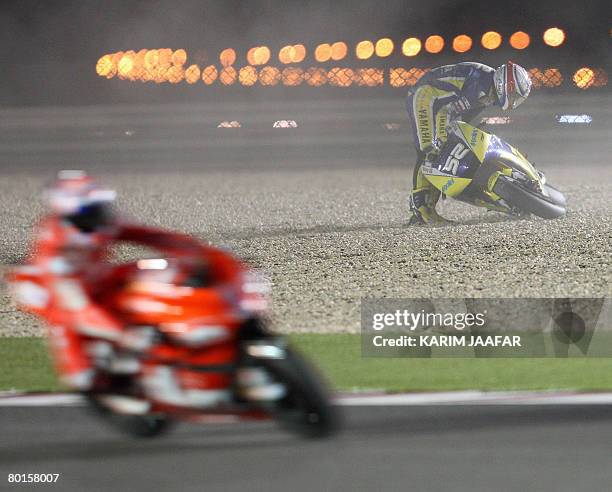 Rider races past Briton James Toseland , 2007 Superbike champion who switched over to MotoGP this season, as he gets back on his feet after falling...