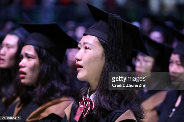 Students react during the graduation ceremony of Shantou University on June 27, 2017 in Shantou, China.