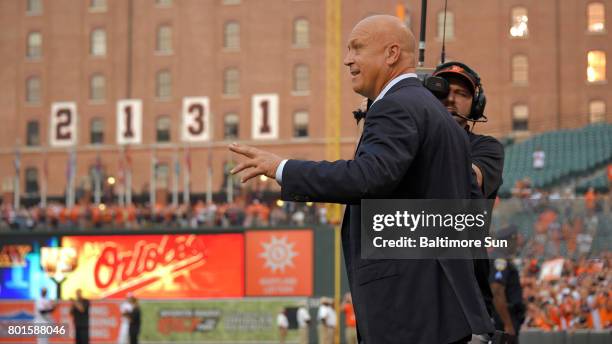 Baseball Hall of Famer, retired Baltimore Orioles infielder Cal Ripken Jr., acknowledges fans as he makes his way from the dugout during the 20th...