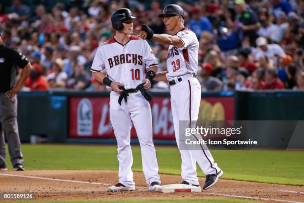 Arizona Diamondbacks catcher Chris Herrmann listens to Arizona Diamondbacks first base coach Dave McKay during the MLB baseball game between the...