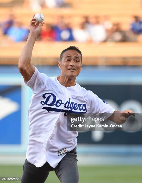 Mark Dacascos, the Chairman on Food Network's television series Iron Chef America, actor and martial artist, throws out the first pitch before the...