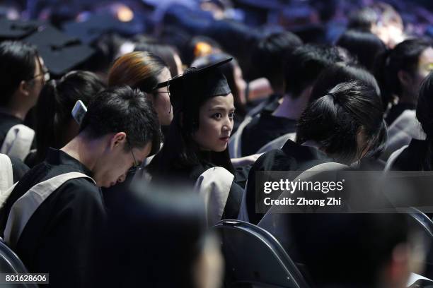 Students react during the graduation ceremony of Shantou University on June 27, 2017 in Shantou, China.