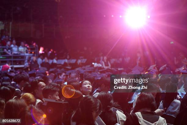 Students react during the graduation ceremony of Shantou University on June 27, 2017 in Shantou, China.