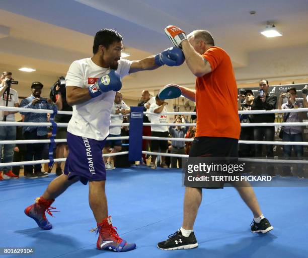 Philippine boxer Manny Pacquiao spars with his trainer Freddie Roach during a training session in Brisbane on June 27, 2017 in preparation for his...