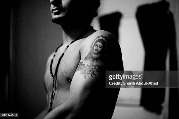 An Iraqi Christian refugee with tattoos depicting Jeasus on his arms, August 18 in the area of Sad el-Bousharya, Beirut. The area has become an Iraqi...