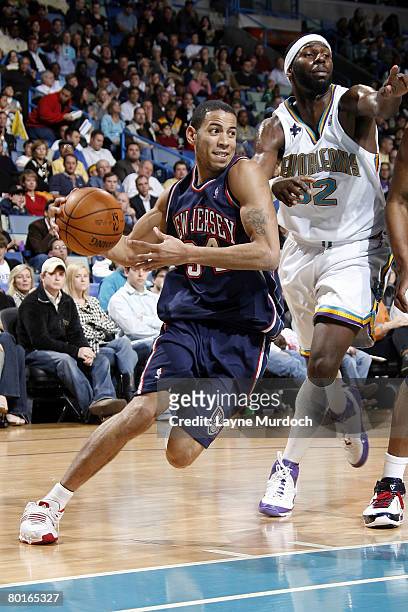 Devin Harris of the New Jersey Nets drives past Julian Wright of the New Orleans Hornets on March 7, 2008 at the New Orleans Arena in New Orleans,...