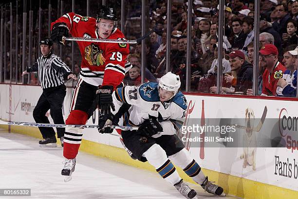 Jonathan Toews of the Chicago Blackhawks tries to get past Torrey Mitchell of the San Jose Sharks on March 7, 2008 at the United Center in Chicago,...