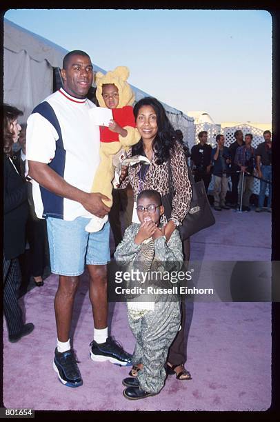 Earvin "Magic" Johnson poses with his wife Cookie, daughter Elisa, and son E.J. October 25, 1997 in Los Angeles, CA. Johnson won five championships...