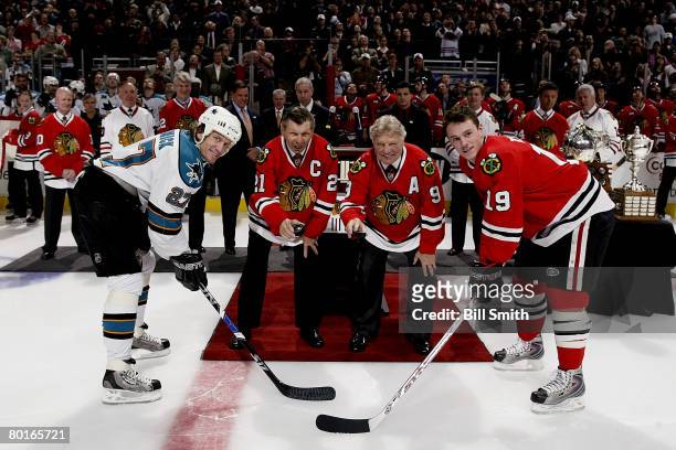 Former players Bobby Hull and Stan Mikita of the Chicago Blackhawks drop the ceremonial puck in a pre-game ceremony in honor of them before the Black...