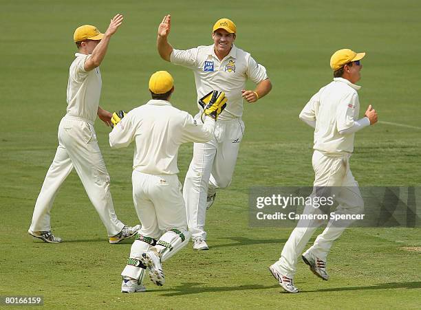 Luke Pomersbach of the Warriors celebrates taking the catch of Michael Di Venuto of Tasmania off the bowling of Ben Edmondson during day two of the...