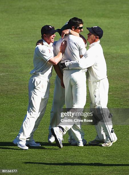 Alastair Cook of England is congratulated after catching Stephen Fleming of New Zealand during day four of the First Test match between New Zealand...